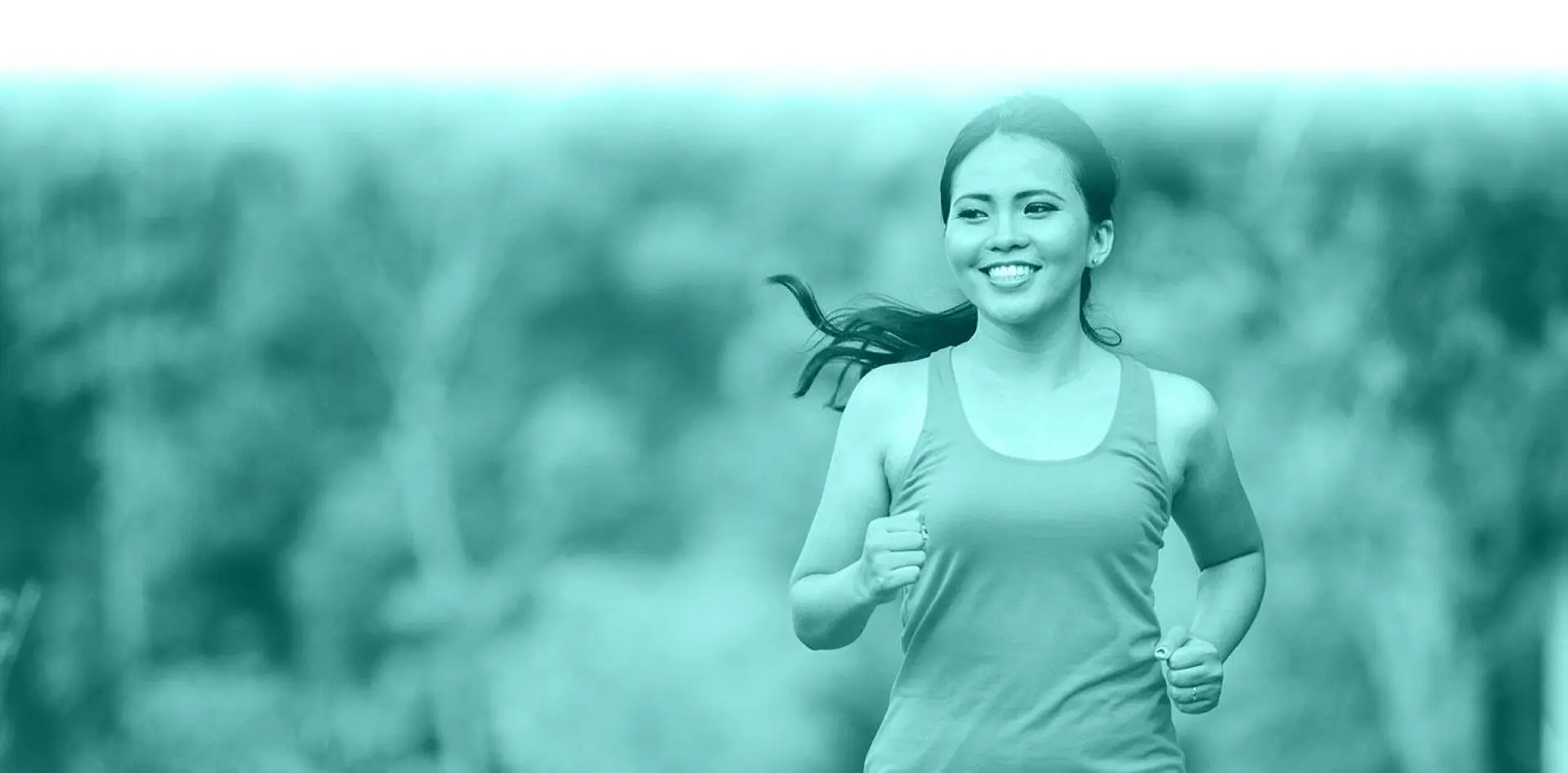 hero 04 Woman jogging outdoors, smiling and energetic.